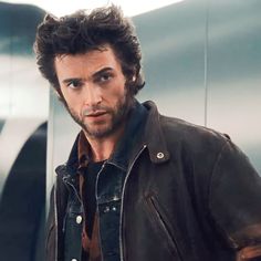 a man wearing a leather jacket and looking at the camera