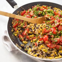 a skillet filled with mexican rice and vegetables