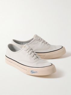 visvim's 'Logan' sneakers are inspired by classic deck shoes. Made from Japanese canvas, they have a low-top profile and comfortable rubber outsoles detailed with the label's moniker and signature waves. Visvim Shoes, Hightop Sneakers, Deck Shoes, Sneakers For Men, Latest Sneakers, Perforated Leather, Sneakers Grey, Suede Sneakers, Flat Sneakers