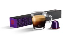 a cup of coffee next to a purple box