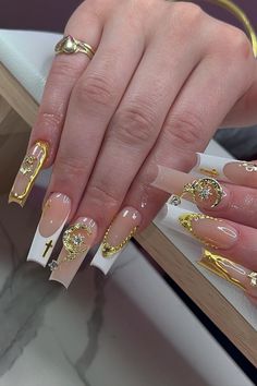 Nails fit for a queen! These striking long cutout-shaped nude nails are adorned with opulent gold charms, creating a luxurious and elegant look. The intricate white French and gold embellishments, along with delicate jewels, elevate this chic design to a whole new level of sophistication. Get ready to turn heads and leave a lasting impression with this stunning manicure! // Photo Credit: Instagram @the.vanilla.nails Super Cute Acrylic Nails, Cute Acrylic Nails Designs, Girly Habits, House Interior Makeover, Gold Nails Prom, Growth Tattoos, Nails 23, Brush Techniques, Nails Brush