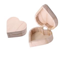 an open heart shaped wooden box on a white background