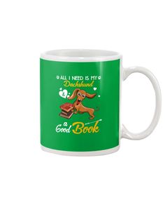 a green coffee mug with an image of a dog on it and the words, all i need is my dachshund as a good book