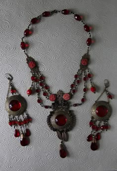 "This listing is for An Art Nouveau Antique 1930's Czech Vibrant Red Color Glass bead, and delicately carved celluloid Festoon Lariat Necklace and Earring Set* A true One of a kind set! The pieces show the patina of time, which makes this a testimonial of a past era. Glamorous and classic chic. Here are the details of this specific gem exactly as shown on pictures: kindly regard that this piece does show wear on the largest glass centerpiece, but otherwise all else is in superb pre_loved conditi Art Nouveau Dress, Unique Jewelry Vintage, Statement Art, Red Jewelry, Jewelry Show, Ruby Jewelry, Necklace And Earring Set, Victorian Jewelry, Earring Jewelry