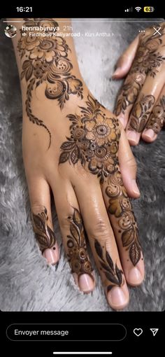 hendi tattoos on someone's hand with flowers and leaves painted on it,