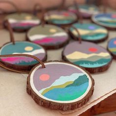 wooden slices with painted designs on them sitting on a table