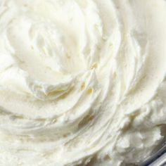 a bowl filled with whipped cream sitting on top of a table