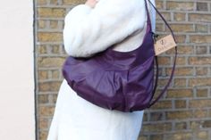 Hobo bag purple leather  Convertible shoulder and cross body Detachable long strap  Internal pockets one zipped and two flap pockets Slouchy violet purse in leather Perfect with any outfit and top zip for security  Also available in black, brown, tan, red, dark olive MEASUREMENTS 30x42cms top zip = #35cms long drop shoulder strap = 33cms Soft Leather Purple Shoulder Bag, Purple Soft Leather Shoulder Bag, Purple Leather Shoulder Bag With Adjustable Strap, Daily Use Purple Soft Leather Shoulder Bag, Purple Leather Satchel With Detachable Strap, Everyday Purple Soft Leather Bag, Chic Purple Leather Hobo Bag, Modern Purple Bag For Everyday Use, Modern Purple Shoulder Bag For Everyday Use