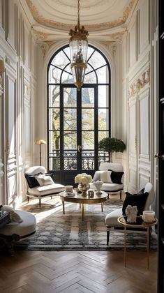 a living room filled with furniture and a chandelier