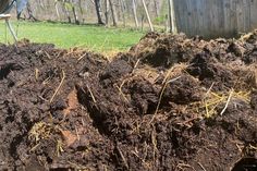 a pile of dirt sitting in the middle of a yard