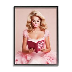 a woman in a pink dress reading a book