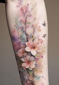 a woman's leg with watercolor flowers and butterflies on the side of her body