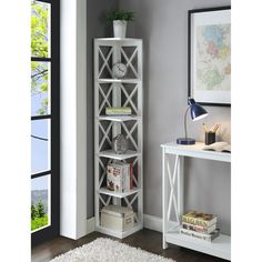 a white book shelf sitting next to a window in a room with a rug on the floor