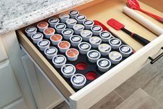 an open drawer in a kitchen with utensils