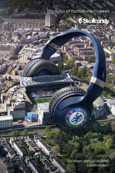 an aerial view of a stadium with headphones on it's ears and in the background is a city