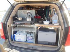 the back end of a van with various items in it