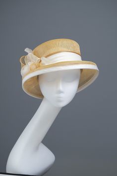 This is a wonderful formal hat. This headpiece is hand formed and sewed, making it an exclusive design. This artisan cocktail hat would perfectly compliment elegant outfit at a wedding or similar event. *Handmade item *Size: 56cm *Fabric : white, yellow sinamay  *Ships worldwide from Poland *More products available on www.joremi.co.uk If you want to make minor changes or create your own design, I encourage you to do so. I am happy to create something especially for you.  All of my products are exclusively designed and completely unique. I invest a great deal of time and attention to create each headpiece and carefully craft it by hand. My extensive experience of over 30 years ensures that all items are made in accordance with the principles developed by many generations of milliners. Elegant Cloche Hat With Structured Crown For Formal Events, Gold Curved Brim Hat For Kentucky Derby, Gold Straw Hat With Short Brim For Party, Fitted Gold Hat With Curved Brim, Formal Sinamay Brimmed Boater Hat, Formal Sinamay Hat With Structured Crown, Gold Short Brim Hat For Kentucky Derby, Yellow Mini Hats For Church, Gold Short Brim Hat For Church