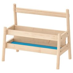 a wooden toy bench with blue cushions