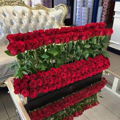 two rows of red roses sitting on top of each other