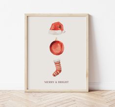 a christmas card with a santa's hat and stocking hanging on the wall