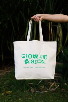 The Growing Season Tote Bag is the perfect everyday companion. Crafted with sturdy cotton canvas and designed with a larger size (20"w, 15"h, 5"d) it can fit all your daily essentials, and any supplies you may need on your adventures. Cotton Tote Weekender Bag For Weekend Trips, Practical Green Cotton Bag, Practical Green Cotton Bags, Large Canvas Bags With Reinforced Handles, Eco-friendly Canvas Bag With Canvas Lining, Cotton Travel Bag With Removable Pouch, Travel Bag With Removable Pouch Made Of Cotton, Practical Cotton Shoulder Bag With Reinforced Handles, Cotton Travel Tote Bag With Canvas Lining