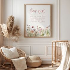 a baby's room with a crib, chair and framed art print on the wall