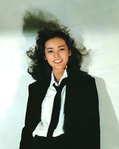 a woman in a black jacket and white shirt