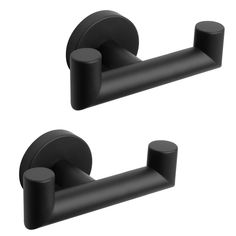 two black towel holders with round handles on each one and an oval handle on the other