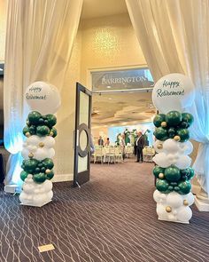 balloons are stacked on top of each other in the middle of a room with white drapes