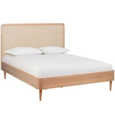 a bed with white sheets and pillows on it's headboard is shown in this image