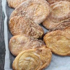 several pastries are sitting on a baking sheet and ready to be baked in the oven