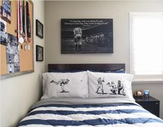 a bed with two pillows and pictures on the wall