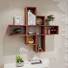 a white desk topped with lots of shelves filled with books and vases on top of it