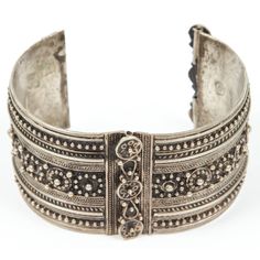 Vintage Moroccan Berber tribal bracelet Moroccan tribal bracelet from the High Atlas of Morocco. Handcrafted by Berber women using Moroccan silver nickel. The ethnic Nomadic and Bedouin jewelry from the Maghreb and North Africa is usually made of silver and the designs are full of symbolism to protect from the evil eye. This bracelet is a stunning piece of Tribal jewelry. Hinged closure. Measures: Inside 2.5" in diameter, outside 3" in diameter. Ethnic Origin: African Features: Ethnic Regional & Traditional Adjustable Sterling Silver Bracelet Nickel Free, Nickel Free Traditional Metal Bracelets, Nickel Free Adjustable Sterling Silver Bracelet, Bohemian Sterling Silver Cuff Bracelet, Heavy Silver Bracelets For Ceremonial Occasions, Handmade Antique Silver Cuff Bracelet For Ceremonial Occasions, Unique Silver Bracelet For Ceremonial Occasions, Silver Metal Cuff Bracelet For Ceremonial Occasions, Festival Bracelet With Intricate Design