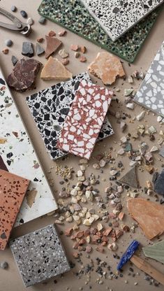 several different types of tiles and tools on a table with rocks, gravel, and stones