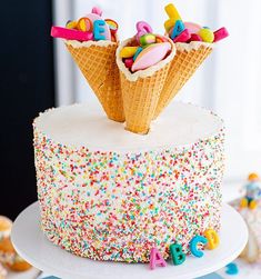 an ice cream cake with sprinkles and letters on top is decorated with colorful icing