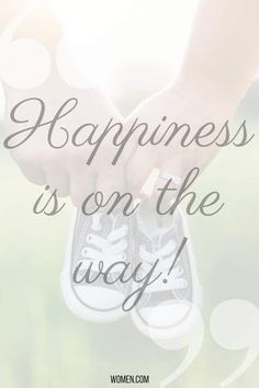 someone holding their shoes with the words happiness is on the way