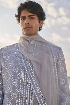 This set features all over mirror work on a raw silk base. It is paired with a grey silk kurta and white straght pant. Complementing stole is also available.From Seema Gujral's Elements collection. DELIVERY TIMEPlease allow 6-8 weeks for your outfit to arrive. FABRIC DETAILSSherwani - Raw Silk Kurta - Silk Trouser - Cotton Dupatta - Tissue Organza Professional cleaning only. Mirror Work Kurtas For Men, Mirror Work Kurta For Men, Grey Sherwani, White Straight Pants, Groom Trends, Ladies Kitty Party Games, Raw Silk Kurta, Indian Wedding Clothes For Men, Seema Gujral