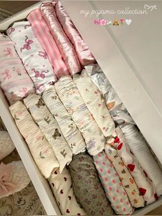 a drawer filled with lots of baby blankets