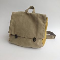 "Khaki Green Satchel Backpack, Backpack Purse, Canvas Rucksack, Vegan Eco Friendly Backpack, Laptop Backpacks, Retro Satchel Purse This lovely satchel backpack bag is a classic and nostalgic one. The bag closes with 2 front bronze clips which integrate beautifully with the fabric colors. The Satchel Backpack can serve you to work, college and even as a diaper bag. it is unique and 100% vegan! ** SPECIFICATIONS ** Features: + Wide adjustable shoulders straps to fit any height. + One internal pock Backpack With Adjustable Strap, Khaki Satchel Backpack With Large Capacity, Khaki Softback Backpack For Travel, Khaki Softback Travel Backpack, Beige Softback Backpack For Outdoor, Functional Canvas Backpack With Adjustable Strap, Beige Rectangular Backpack For Outdoor, Functional Khaki School Backpack, Rectangular Khaki Backpack For Travel