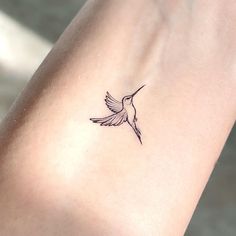 a small hummingbird tattoo on the wrist