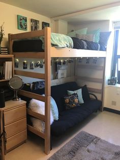 a bunk bed with futon underneath it in a room next to a dresser and window