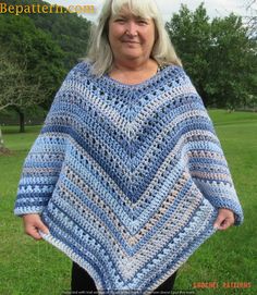 a woman wearing a blue and white crocheted ponchy with her hands on her hips