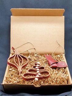 an open cardboard box containing scissors and other items