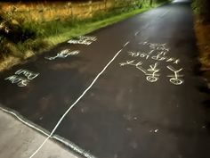 the road has writing on it in chalk