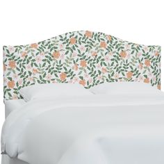 an upholstered headboard with flowers and leaves on it