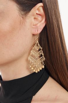 Elevate your accessory game with these captivating statement earrings. Made with top-quality gold-plated brass, these earrings exude a luxurious appeal. The intricate design, complemented by dainty bead accents, showcases exquisite craftsmanship, making it perfect for special occasions or everyday wear. Its chunky yet elegant style is sure to draw compliments and be a conversation starter. Whether paired with a chic dress or casual outfit, these earrings are a testament to timeless beauty and sophisticated design. Gold Bohemian Chandelier Earrings With Dangling Beads, Gold Linear Earrings With Dangling Beads For Party, Festive Tassel Drop Earrings, Festive Metal Drop Chandelier Earrings, Brass Dangle Earrings With Gold Beads, Metal Tassel Drop Earrings For Pierced Ears, Gold Beaded Dangle Chandelier Earrings, Gold Beaded Drop Earrings, Gold Beads Brass Dangle Earrings