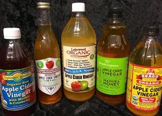 several bottles of apple cider are lined up