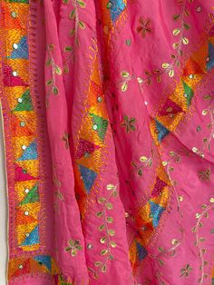 This elegant traditional Dark Pink Bridal Phulkari Dupatta is expertly crafted from Chinon Silk, with Gotta Patti and phulkari hand embroidery all over. The perfect choice for weddings, sangeet, jaago, and chunni ceremonies. Material: Semi silk chinonWork: Silk thread phulkari handwork, needlework, gotta patti workPattern: FloralSize: Full Size 2.5 metersDispatched in 1-3 business days Product Note:​ This is a handcrafted product from artisans and producer groups and due to the nature of the pro Pink Semi-stitched Traditional Wear For Festival, Traditional Pink Silk Thread Choli, Multicolor Salwar Kameez With Pallu For Festival, Traditional Pink Choli With Dupatta, Diwali Festival Salwar Kameez With Cutdana, Pink Kundan Saree For Festivals, Eid Festival Salwar Kameez With Cutdana, Cutdana Salwar Kameez For Diwali, Cutdana Salwar Kameez For Diwali Festival