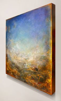 an abstract painting with gold and blue colors